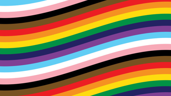 The rainbow-plus colors of the LGBTQIA flag shown as if the flag was waving